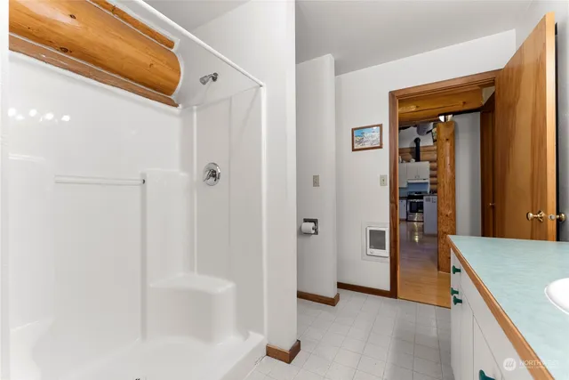 a bedroom with a bed and a night stand