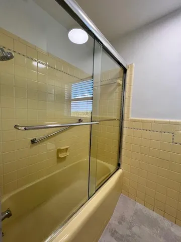 a bathroom with a shower and a bath tub