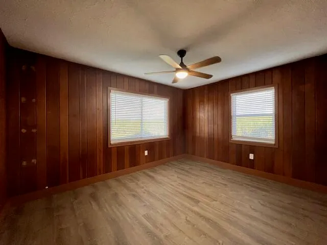 an empty room with windows and closet
