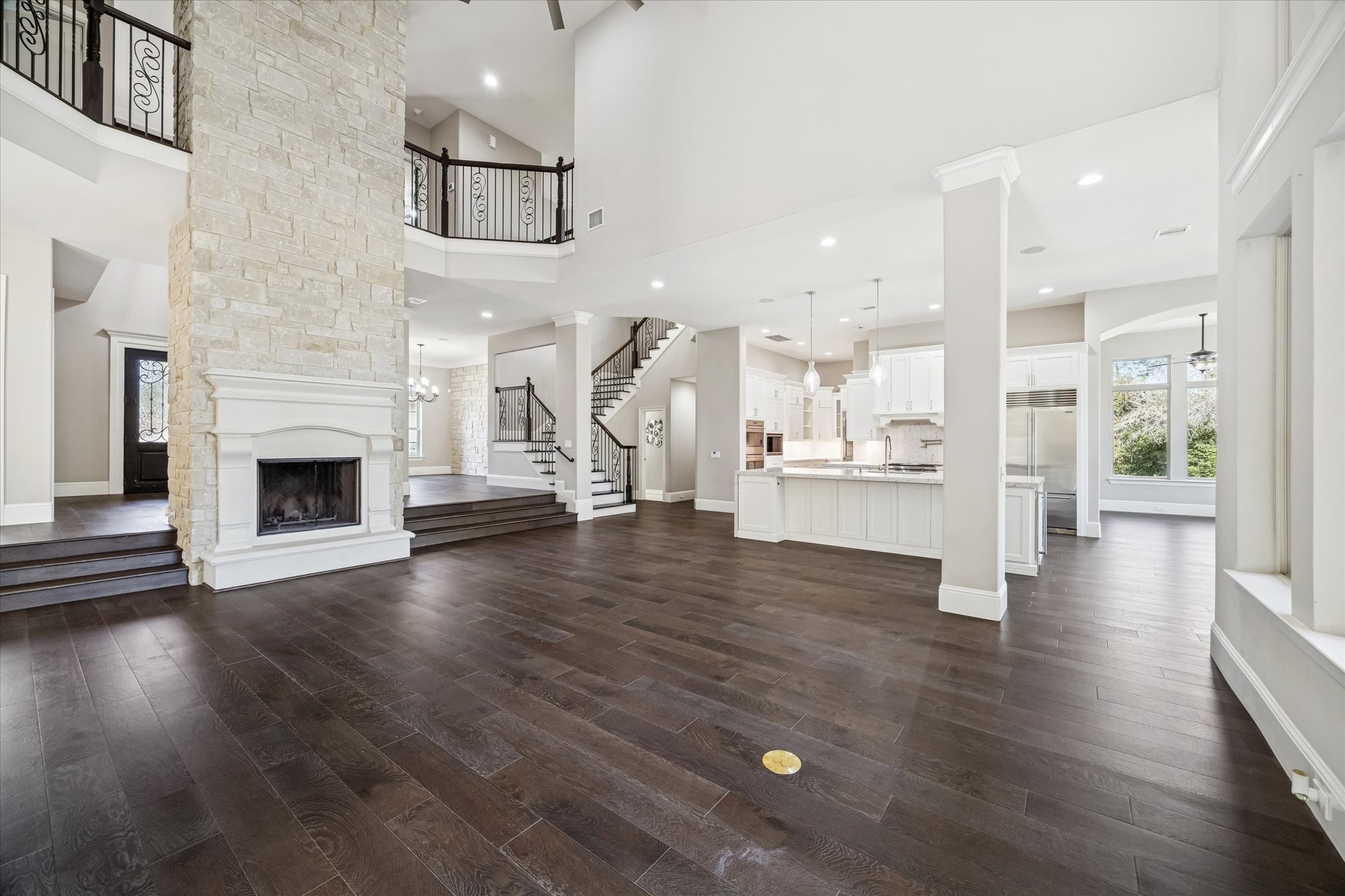 21018 Kings River Point Kingwood, TX 77346 - Photo 13 of 50 an empty room with wooden floor and a kitchen view
