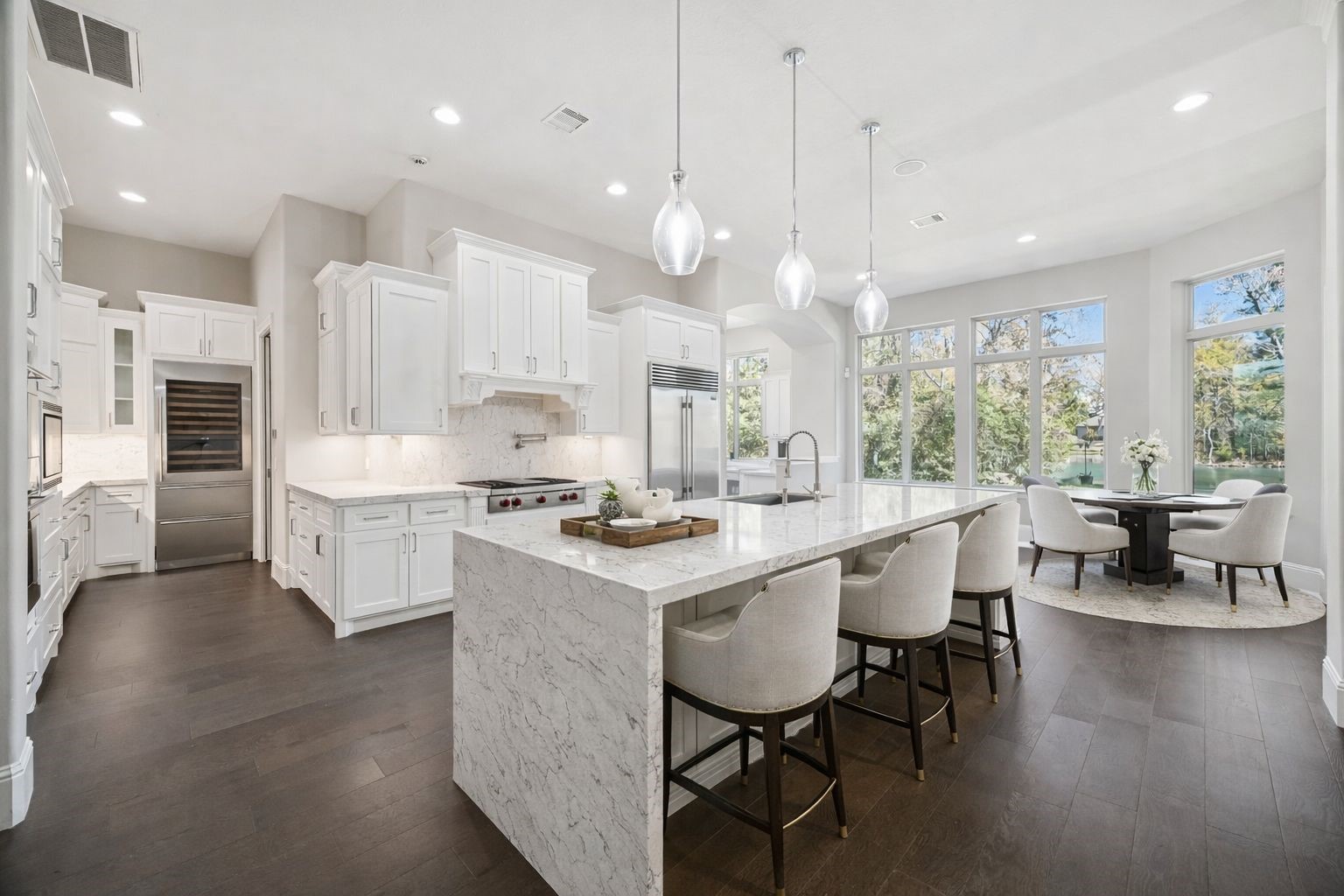 21018 Kings River Point Kingwood, TX 77346 - Photo 19 of 50 a large kitchen with kitchen island a sink table and chairs