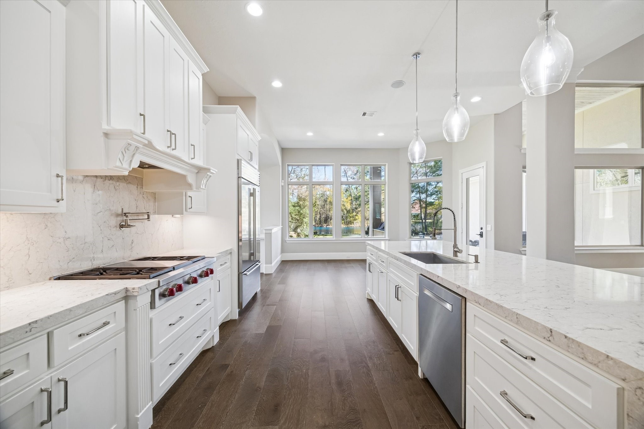 21018 Kings River Point Kingwood, TX 77346 - Photo 22 of 50 a large kitchen with stainless steel appliances a lot of counter space and a wooden floors