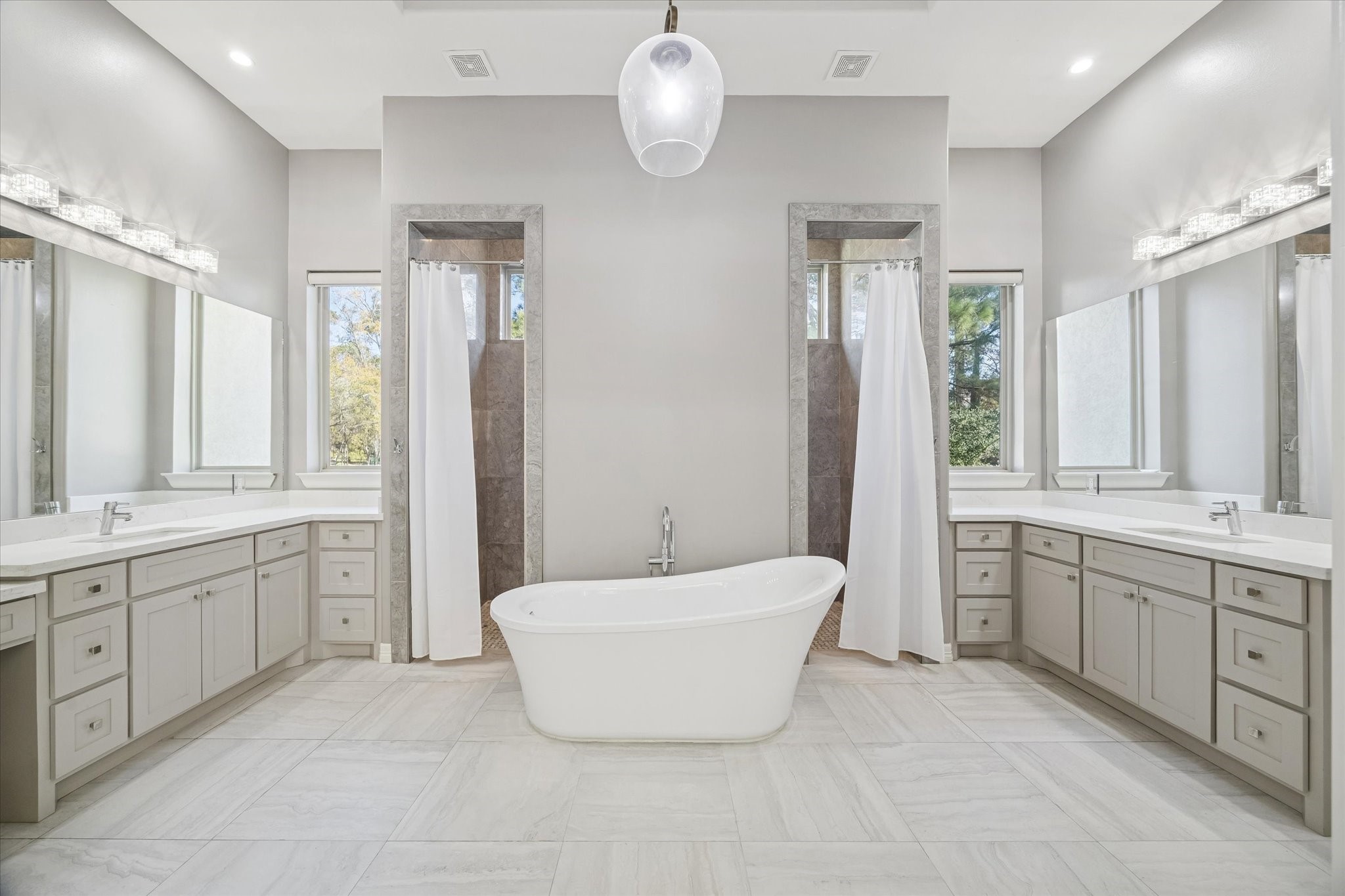 21018 Kings River Point Kingwood, TX 77346 - Photo 28 of 50 a spacious bathroom with a double vanity sink mirror and bathtub