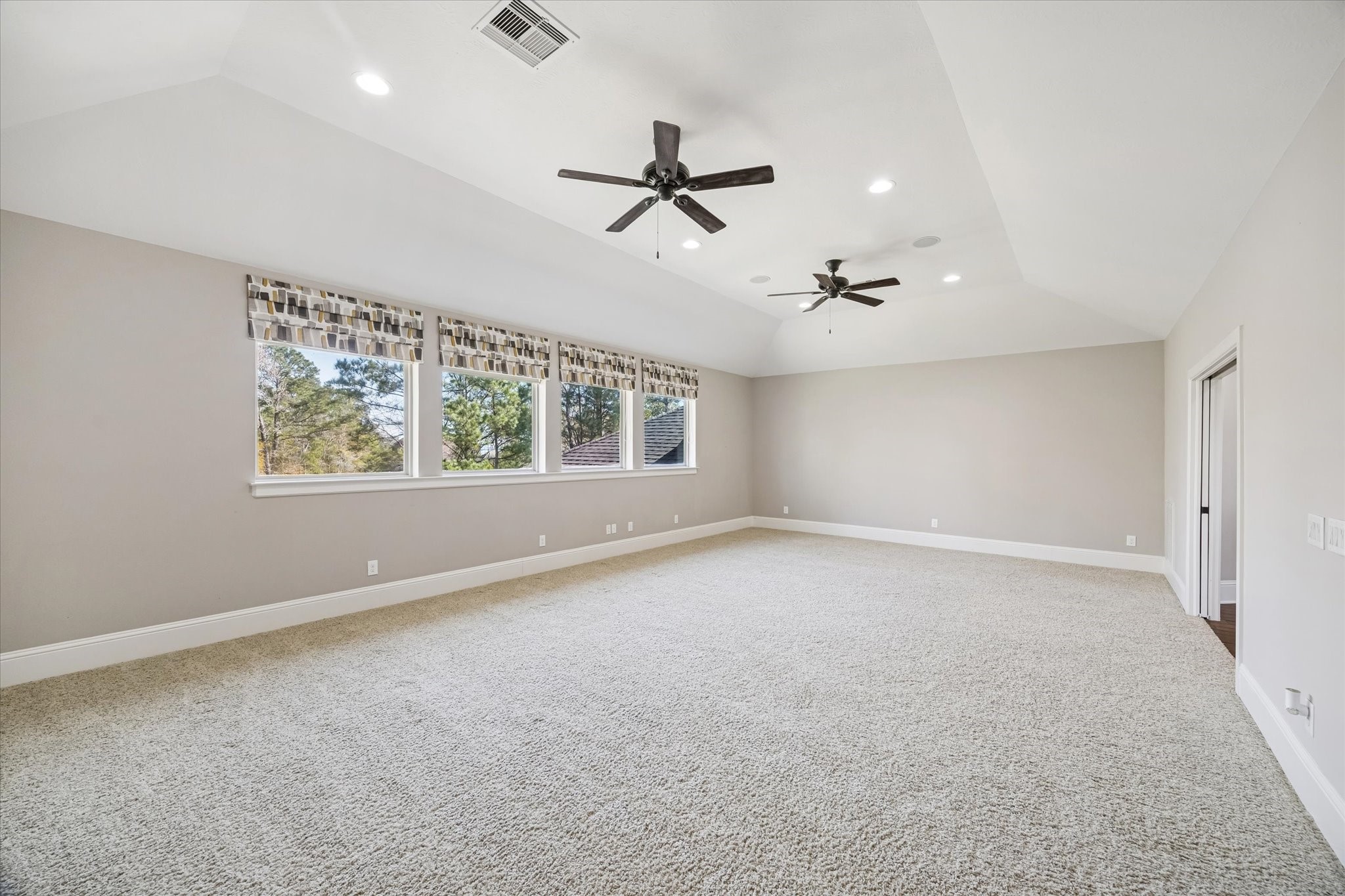 21018 Kings River Point Kingwood, TX 77346 - Photo 35 of 50 an empty room with windows and ceiling fan