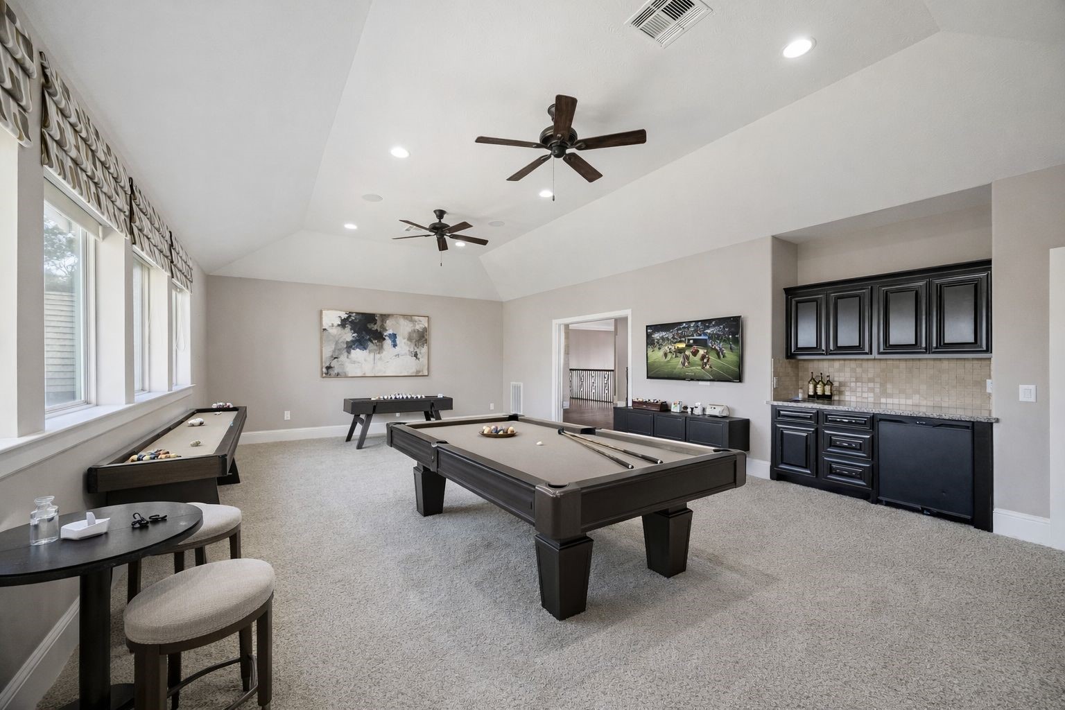 21018 Kings River Point Kingwood, TX 77346 - Photo 36 of 50 a kitchen with a stove a sink dishwasher a dining table and chairs with wooden floor