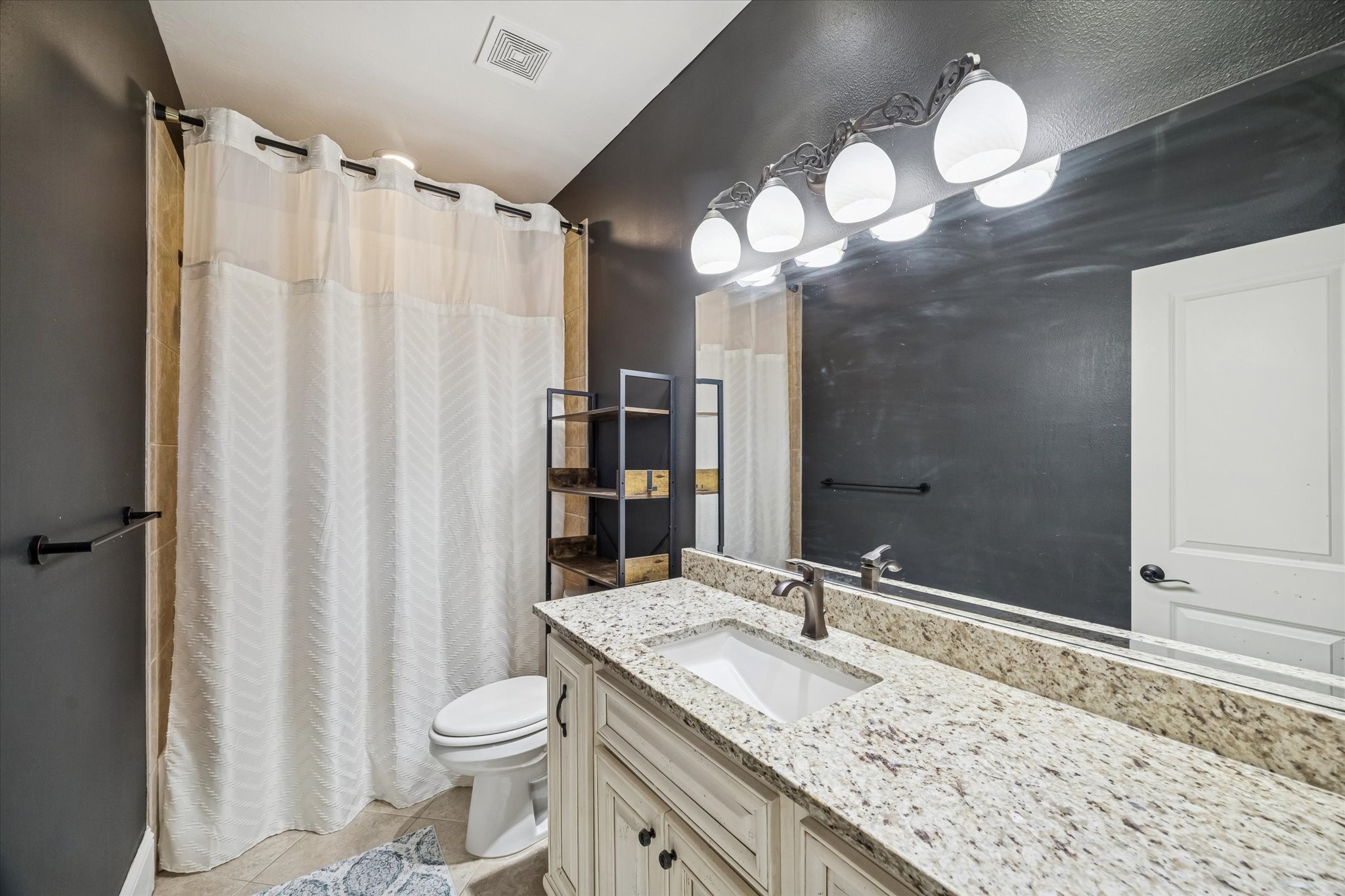 21018 Kings River Point Kingwood, TX 77346 - Photo 38 of 50 a bathroom with a granite countertop sink toilet and shower