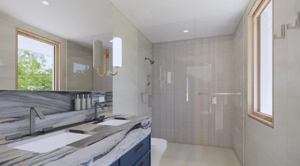 a bathroom with a sink a toilet and shower