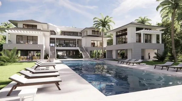 a front view of a house with garden and sitting area