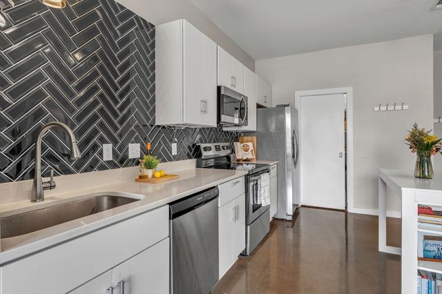 a kitchen with a sink stove and refrigerator