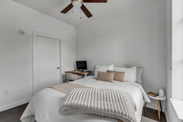 a bedroom with a bed and a tv