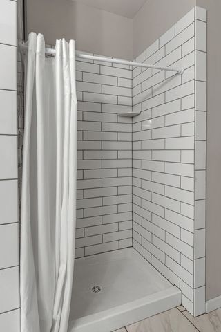 a bathroom with a shower and a bathtub