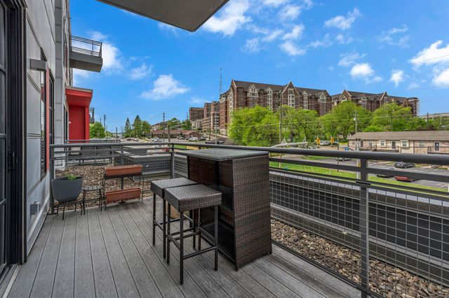 a view of a chairs and table in the balcony