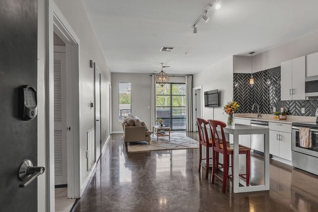 a view of a kitchen with dining table and chairs