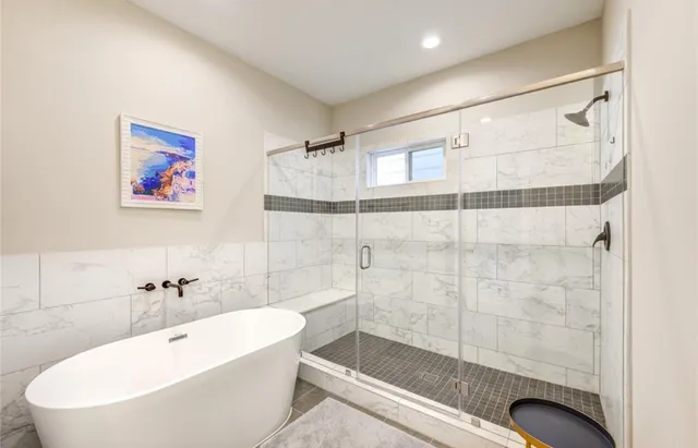 a bathroom with a bathtub and shower
