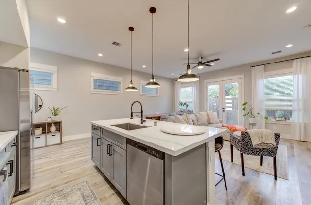 a kitchen with sink stove and chairs