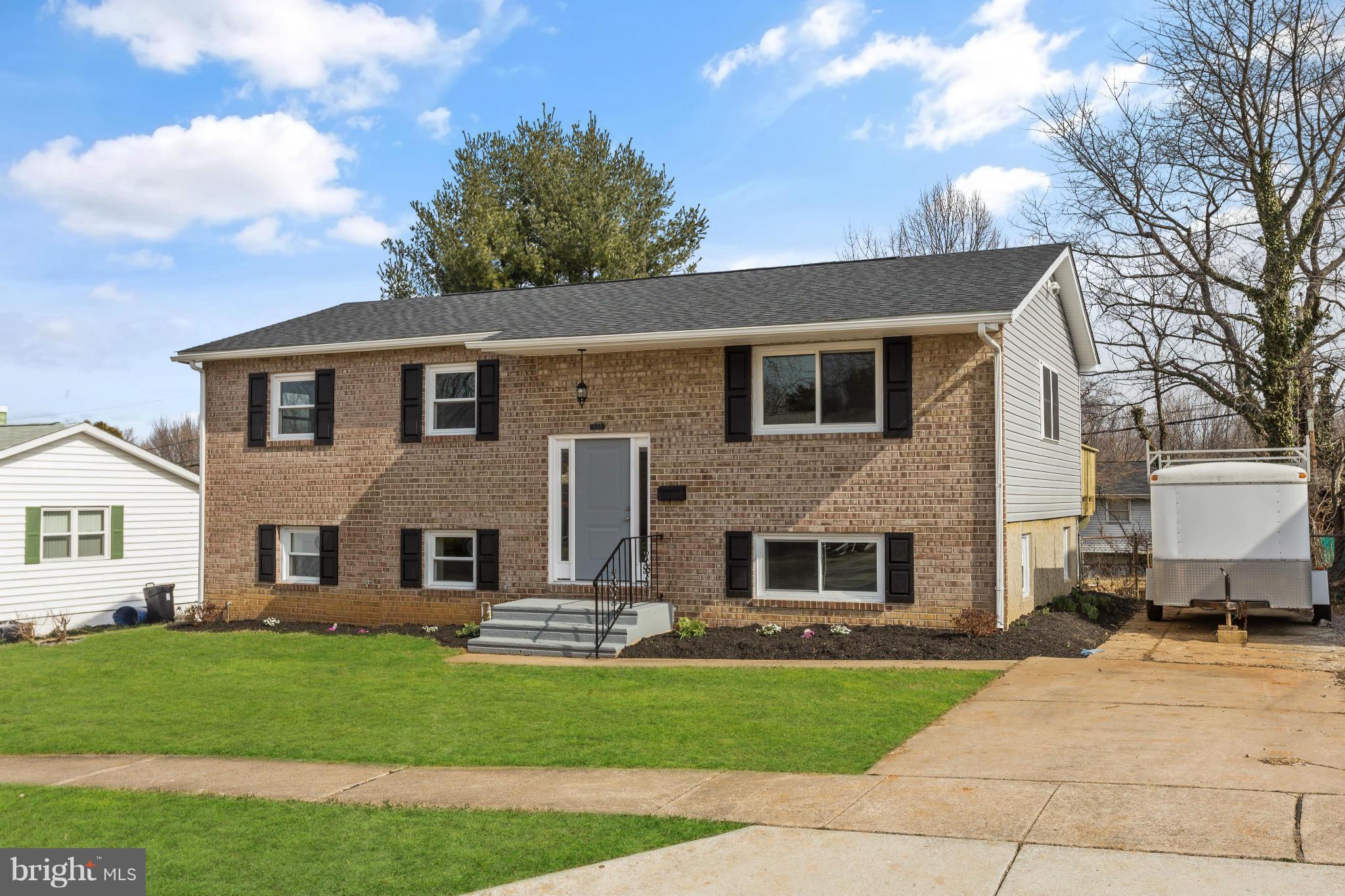 6718 Brompton Road Baltimore, MD 21207 - Photo 1 of 1 a front view of a house with a garden