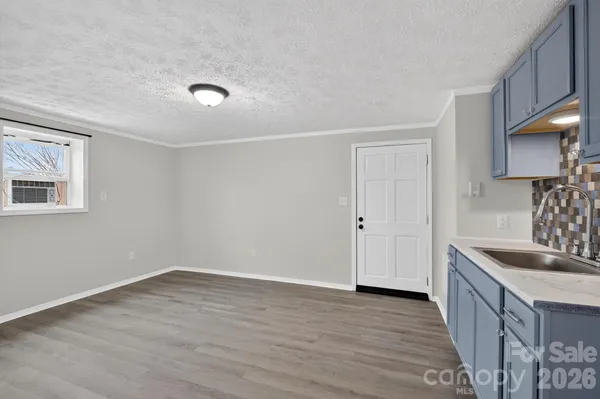 a kitchen with sink and cabinets