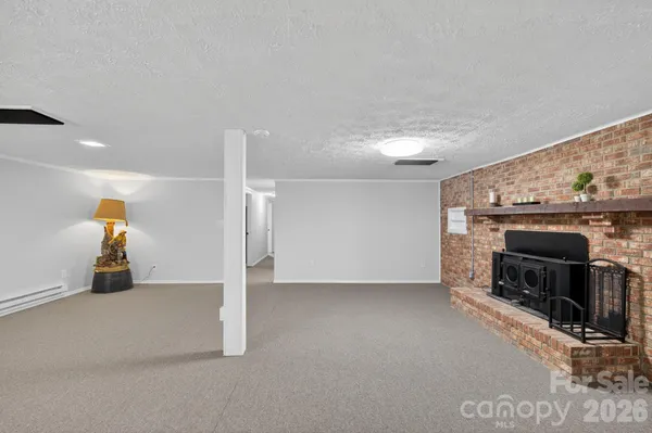 a view of an empty room with fire place and a fireplace