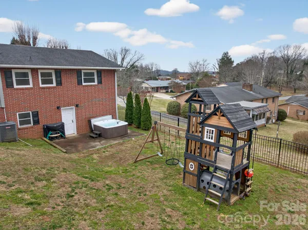 a view of a backyard with sitting area and slide