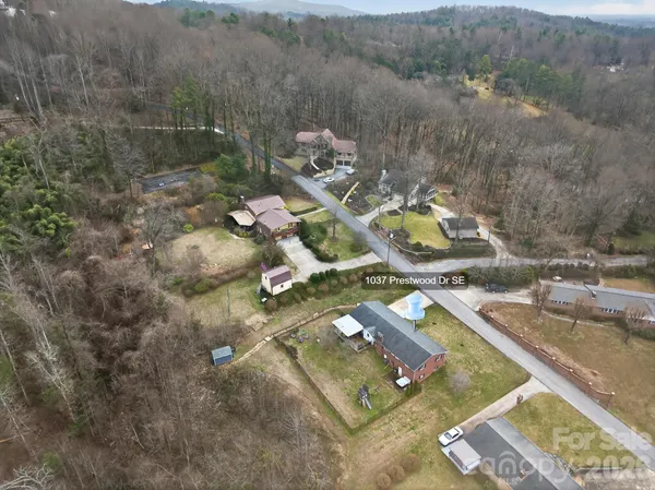an aerial view of a house with a yard
