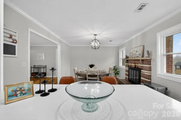 a room with furniture a chandelier a mirror and a window