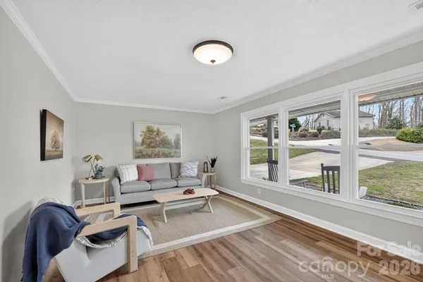 a living room with furniture and a floor to ceiling window