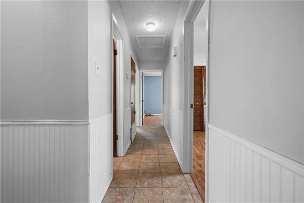 a view of a hallway with wooden shelves