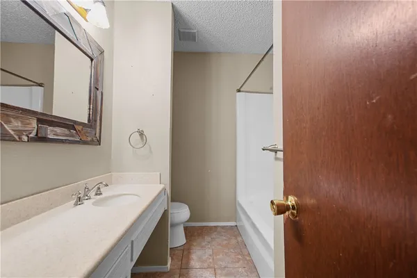 a bathroom with a sink and mirror with toilet