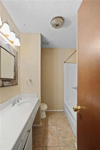 a bathroom with a sink a toilet and mirror