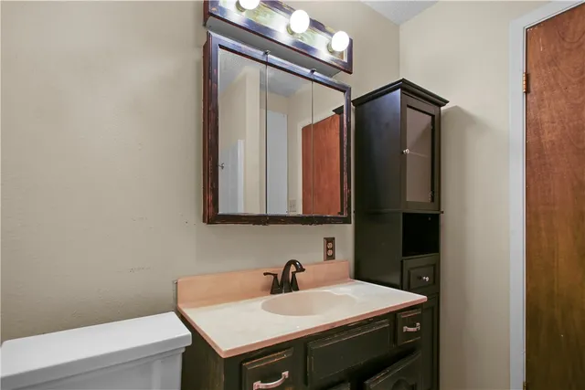 a bathroom with a sink a vanity and a mirror