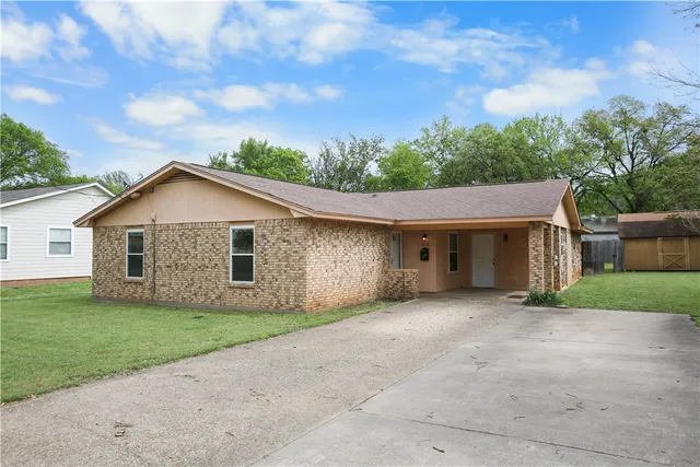 a front view of house with yard and trees