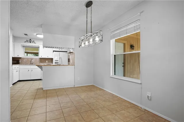 a view of a kitchen with a sink and dishwasher with wooden floor
