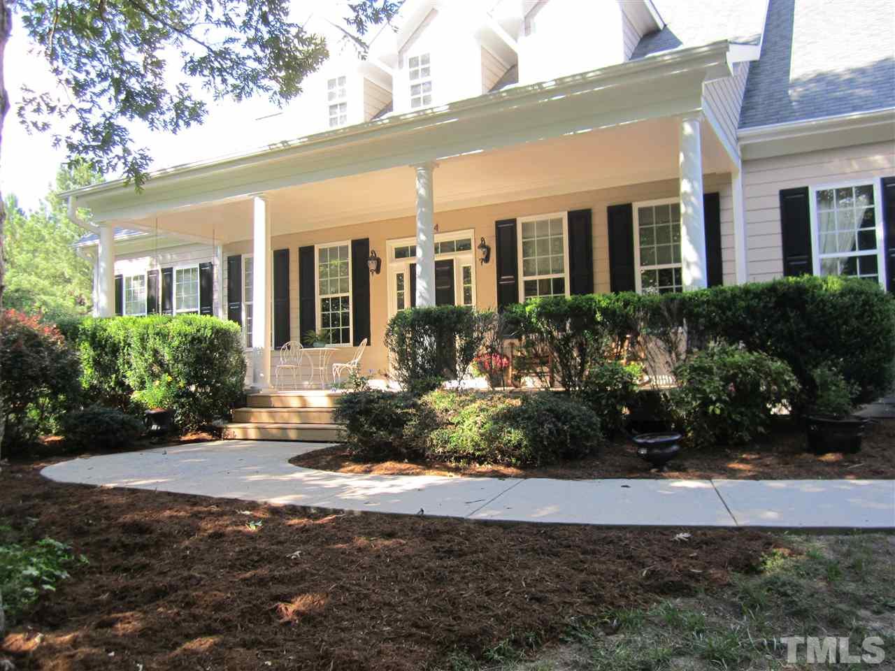 6844 Pond Road Wendell, NC 27591 - Photo 1 of 25 a front view of a house with garden