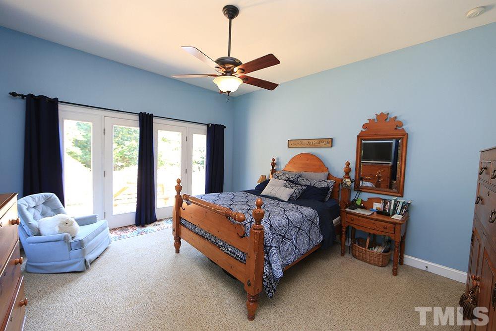6844 Pond Road Wendell, NC 27591 - Photo 11 of 25 a bedroom with a bed and wooden floor