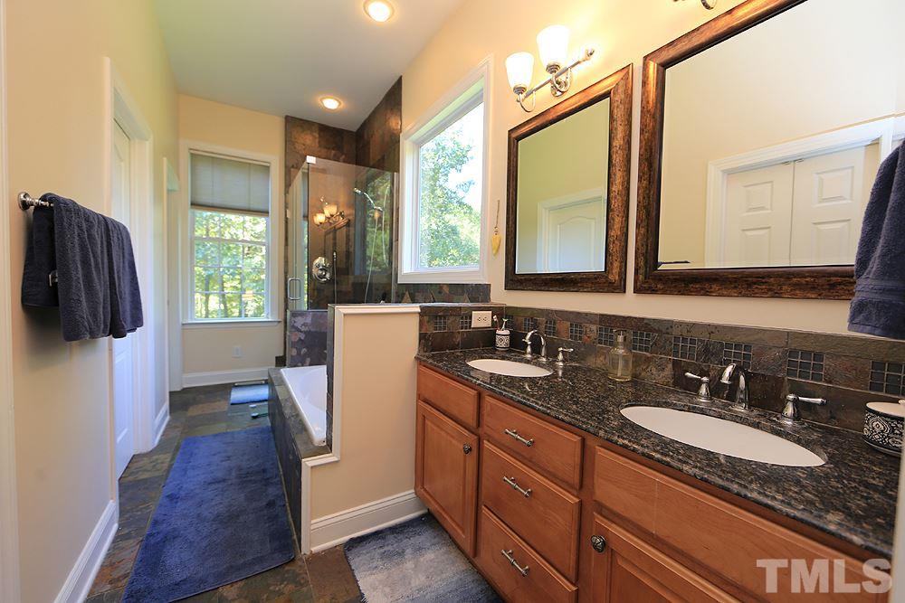 6844 Pond Road Wendell, NC 27591 - Photo 13 of 25 a bathroom with a granite countertop sink and a mirror