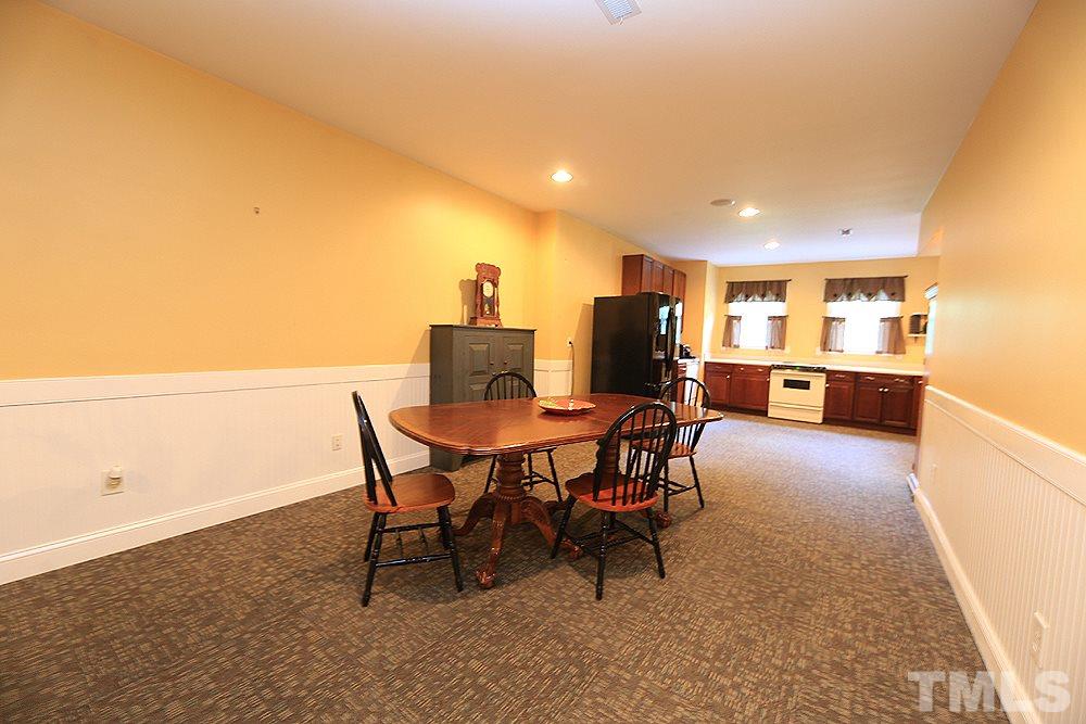 6844 Pond Road Wendell, NC 27591 - Photo 16 of 25 a view of a dining room with furniture and a kitchen