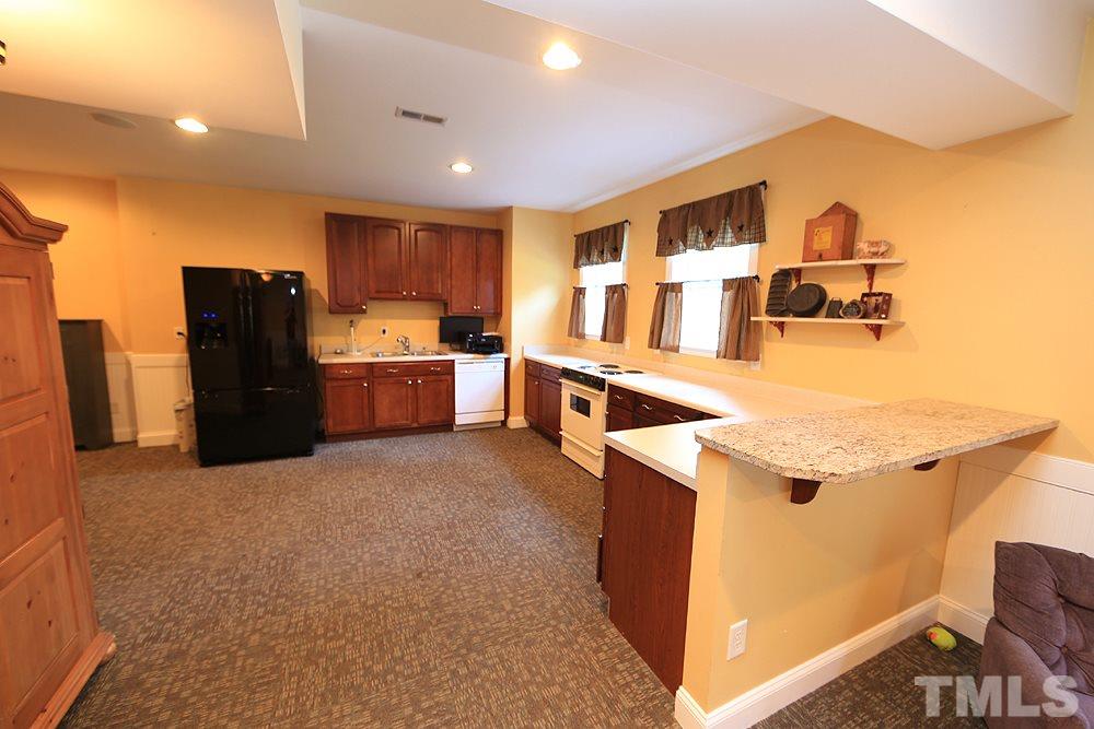 6844 Pond Road Wendell, NC 27591 - Photo 17 of 25 a view of kitchen with furniture and refrigerator