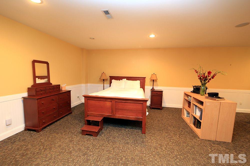 6844 Pond Road Wendell, NC 27591 - Photo 18 of 25 a spacious bedroom with a bed and a desk