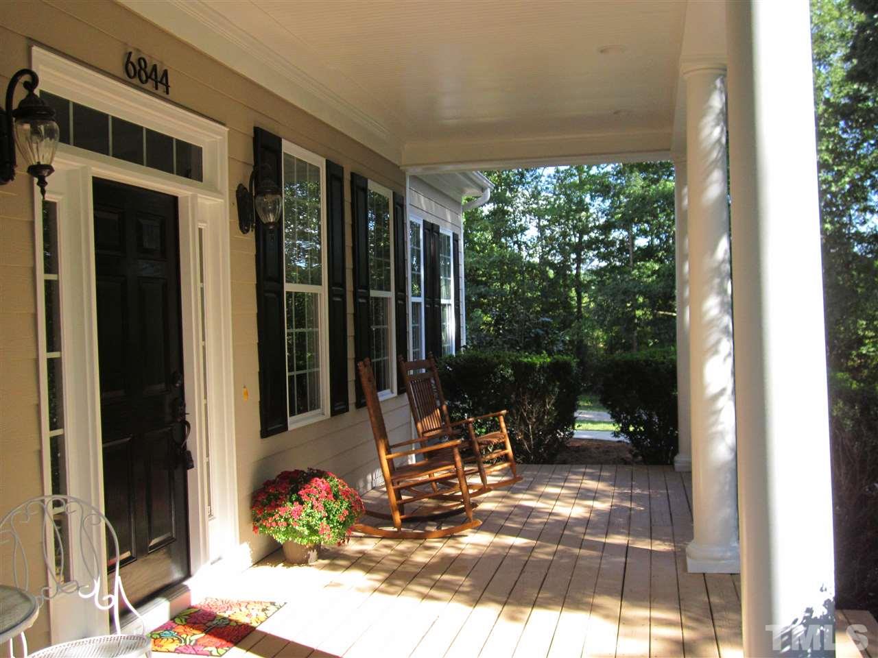 6844 Pond Road Wendell, NC 27591 - Photo 3 of 25 a view of a porch with chairs and front door