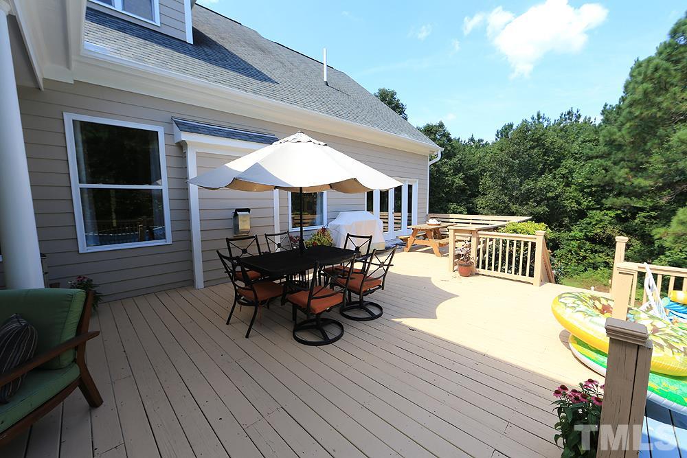 6844 Pond Road Wendell, NC 27591 - Photo 21 of 25 a view of a house with wooden deck outdoor seating