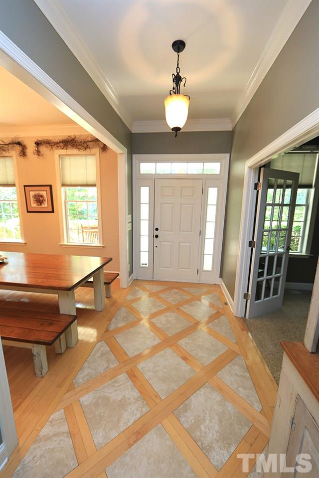 6844 Pond Road Wendell, NC 27591 - Photo 4 of 25 a view of an entryway with wooden floor and chandelier