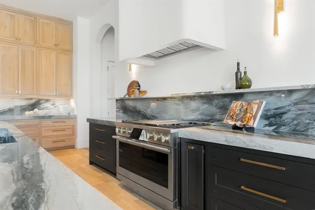 a kitchen with stainless steel appliances granite countertop a stove and a sink