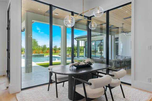 a view of a dining room with furniture large windows and wooden floor
