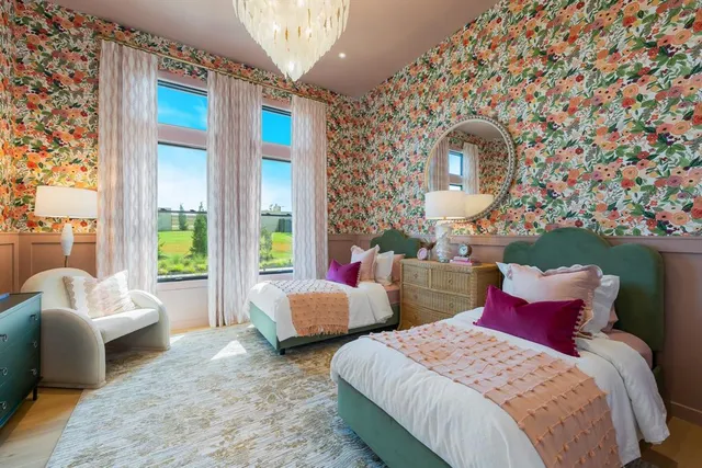 a bedroom with two beds and a large window