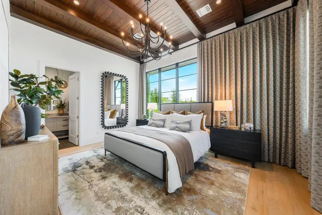 a bedroom with a bed potted plant with the outer view