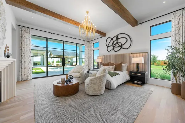a living room with furniture ceiling fan and a floor to ceiling window