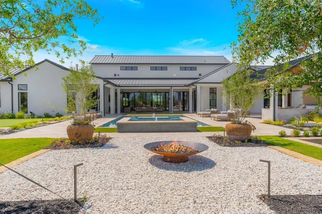 a view of a house with patio and a yard