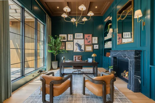 a living room with furniture a chandelier and a large window