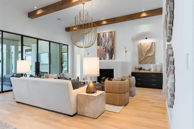 a living room with furniture a large window and a fireplace