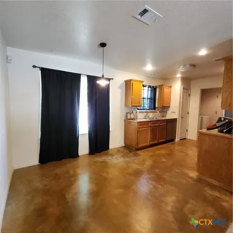 a kitchen with a sink and a window